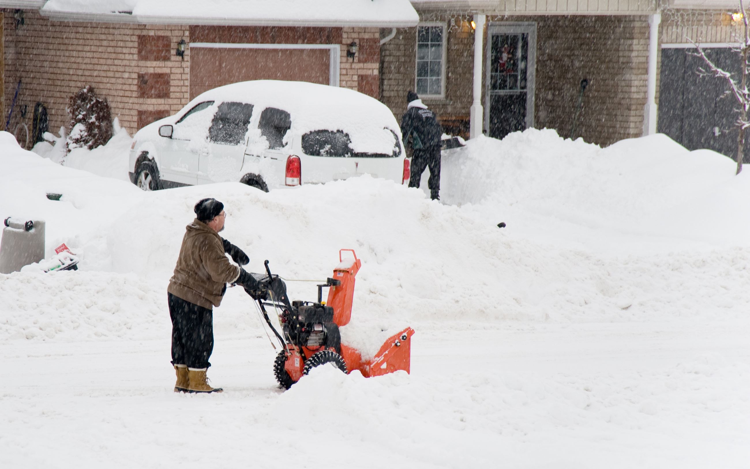 Picture of individual blowing snow with a snow blower